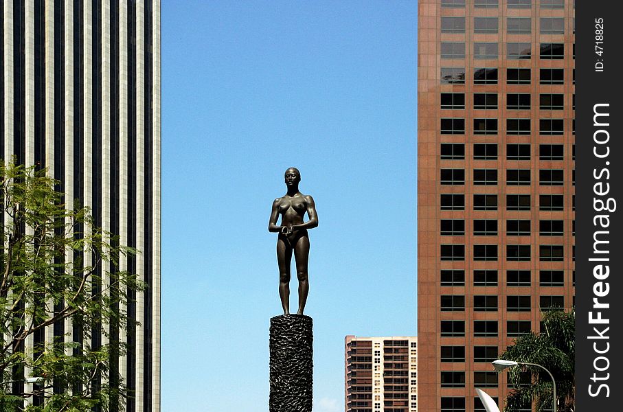 Statue Between Skyscrapers