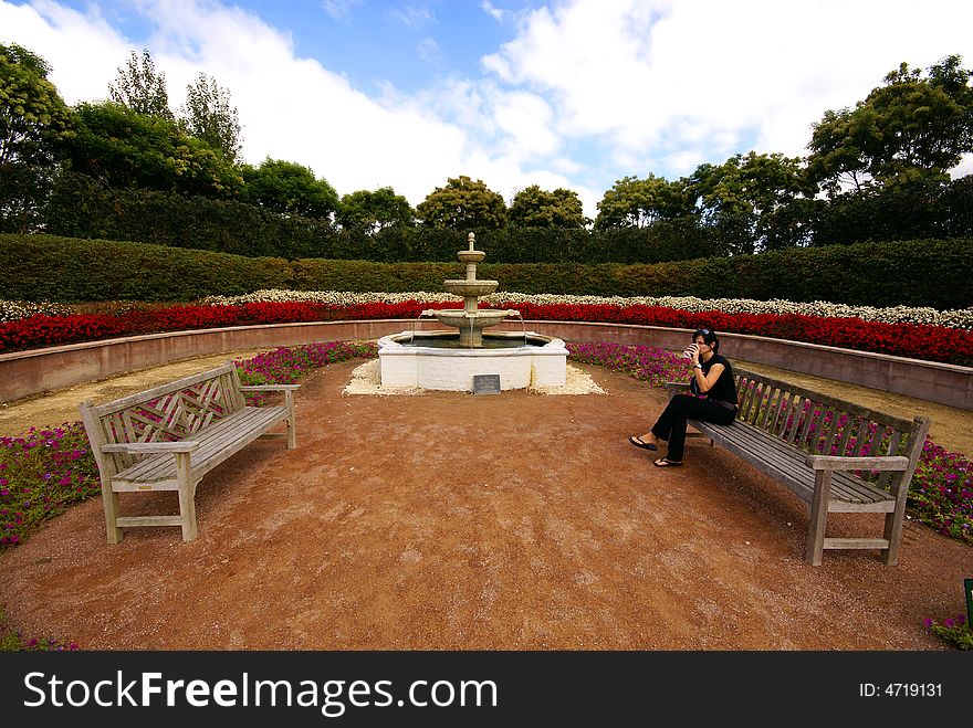 Young woman is having coffee break in beautiful garden. Young woman is having coffee break in beautiful garden