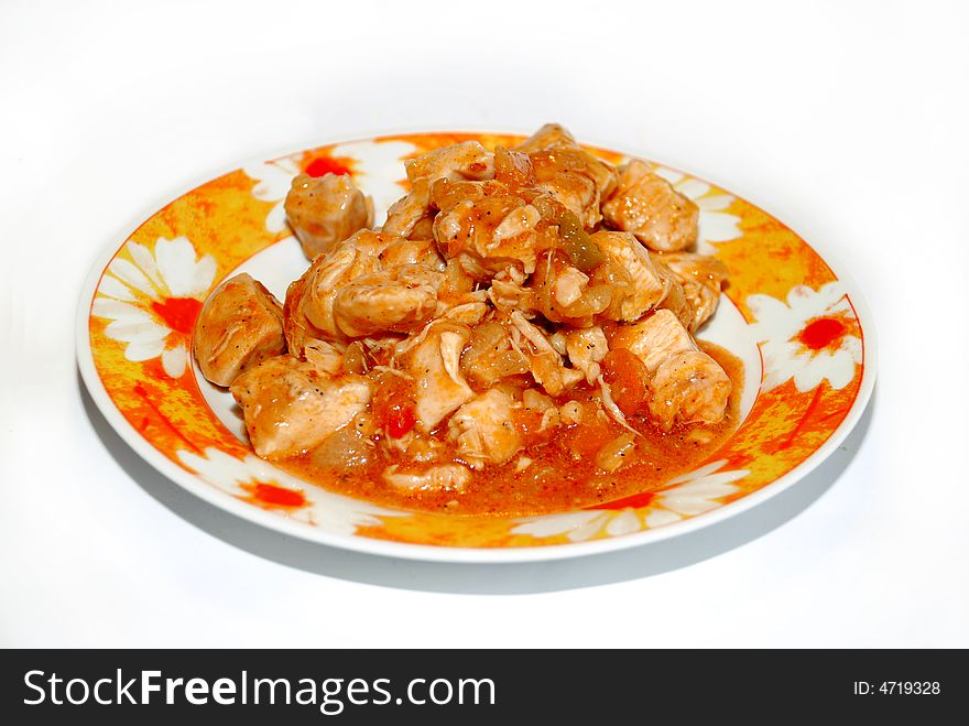 Meat pieces in orange piquant sauce on plate isolated over white. Meat pieces in orange piquant sauce on plate isolated over white