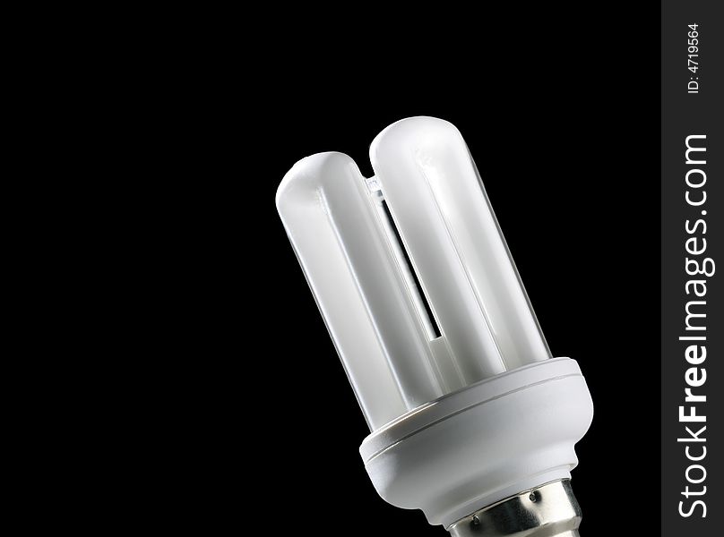 Close-up of low energy light bulb on black