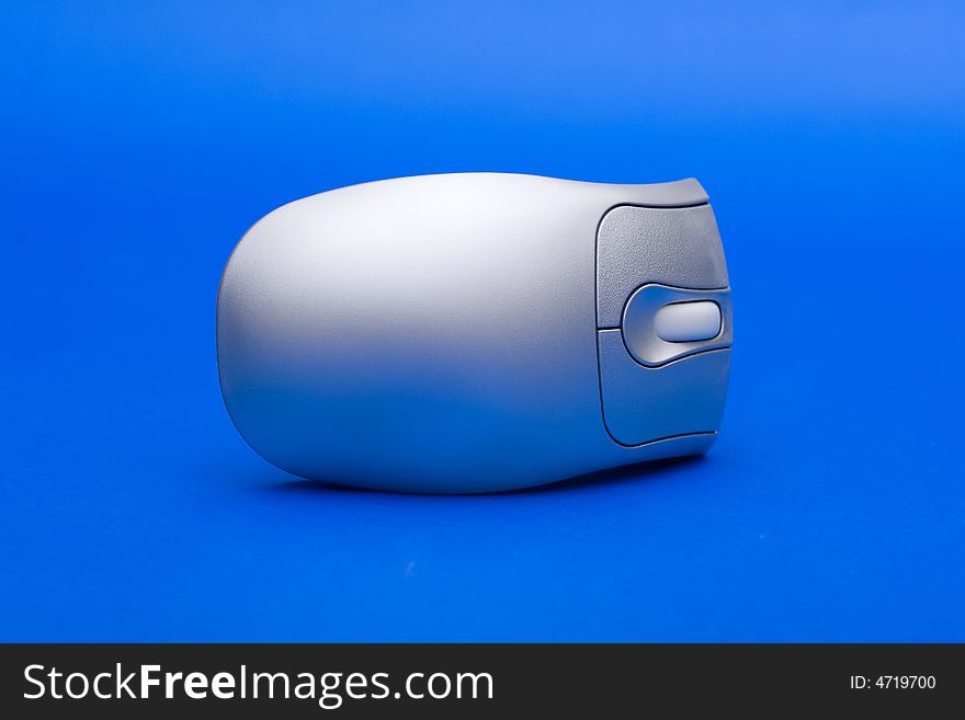 Silver PC mouse against the blue background