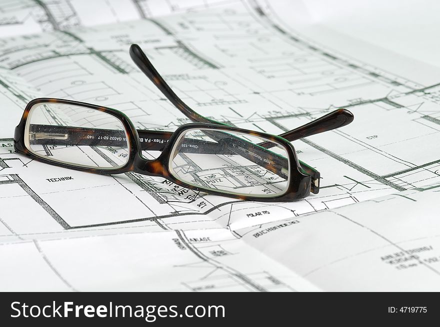 A big building plan with glasses