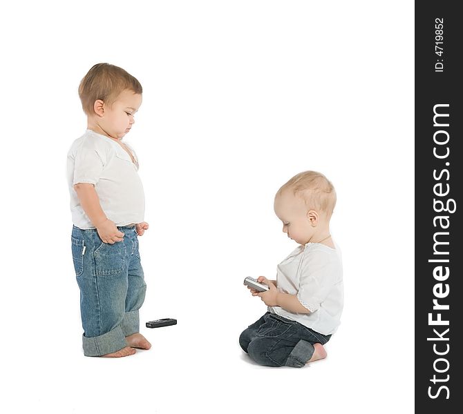 Two little boys with cellphones, white background. Two little boys with cellphones, white background