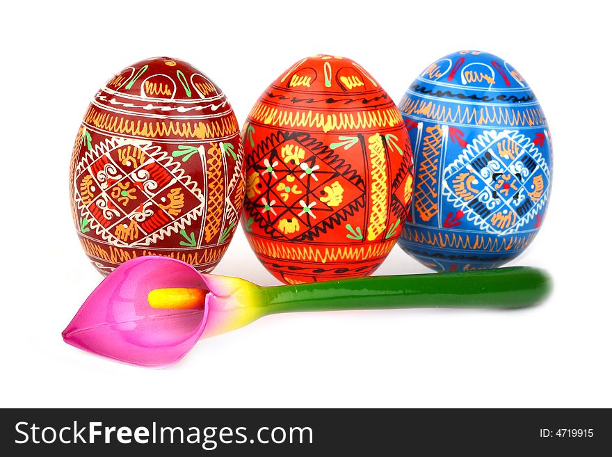 Three russian tradition easter eggs abreast and violet orchid over white