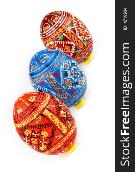 Three russian tradition easter eggs diagonally over white