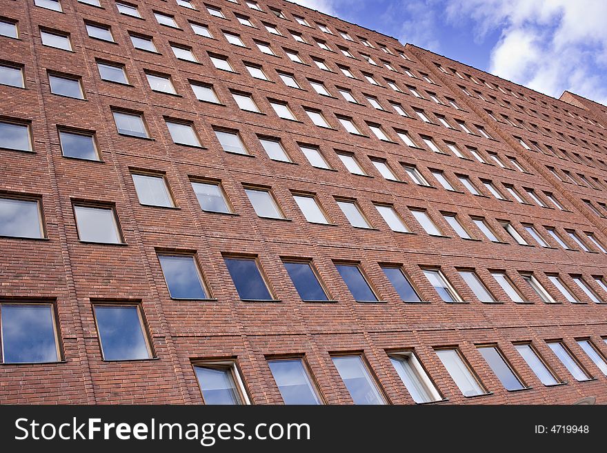 A picture of a red brick building and a nice blue sky. A picture of a red brick building and a nice blue sky