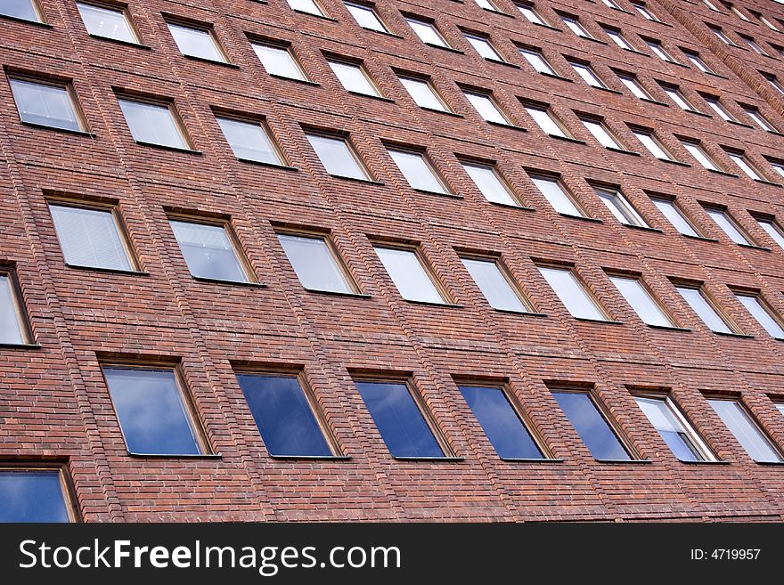 Front Of A Brick Building And A Nice Blue Sky