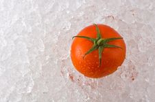 A Red Ripe Tomato On A Bed Of Ice Stock Photo A Red Ripe Tomato On A Bed Of Ice Stock Photo