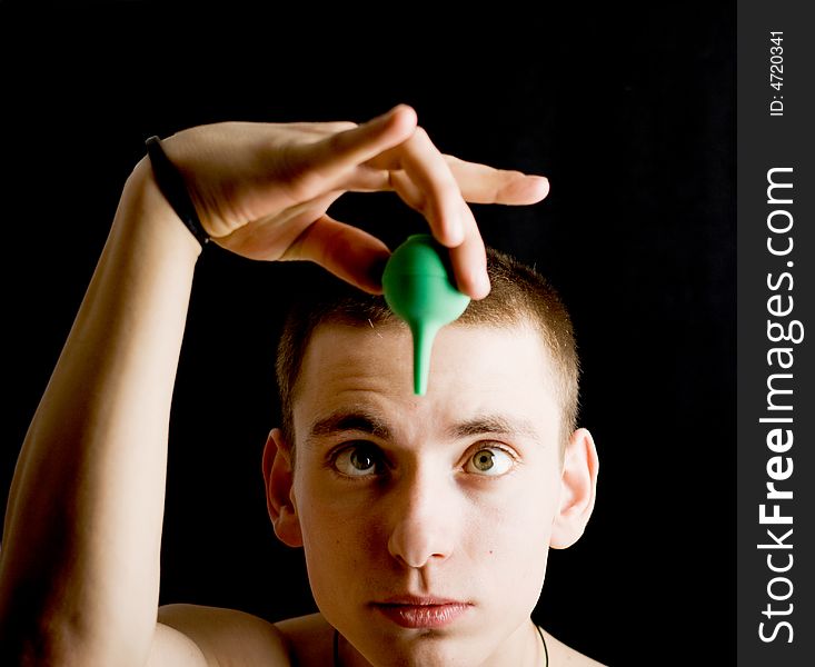 Naked man with medicine syringe. Isolated on black.