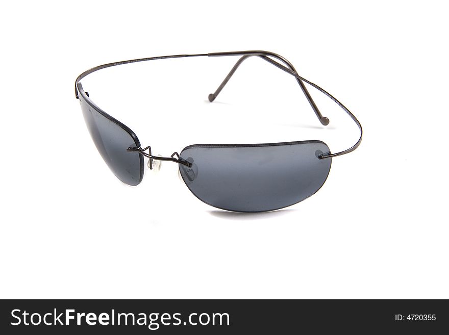 A pair of dark wire rimmed sunglasses on a white background