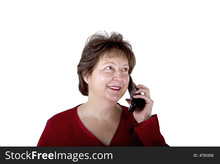 A middle aged woman in red blouse talking on a phone against white background. A middle aged woman in red blouse talking on a phone against white background