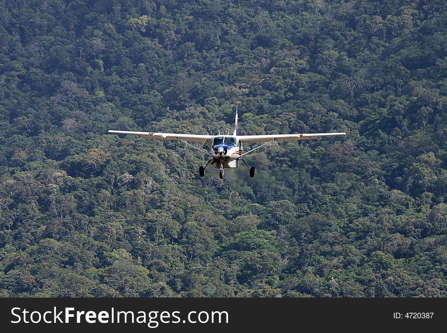Plane flying over an isolated rainforest- exploration or exploitation?