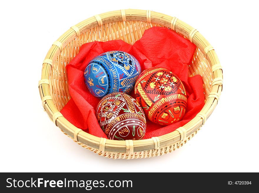 Three russian tradition easter eggs in yellow basket over white. Three russian tradition easter eggs in yellow basket over white
