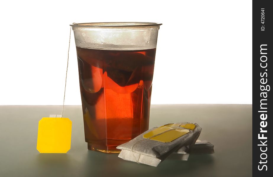 Tea bags and plastic glass with tea. Tea bags and plastic glass with tea