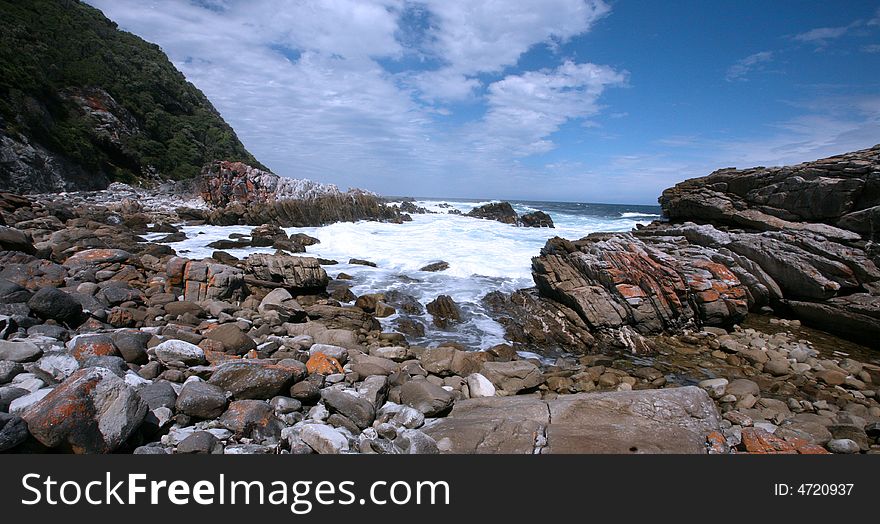 View on Indian Ocean from rocky shores of Victoria Bay in Western Cape, South Africa