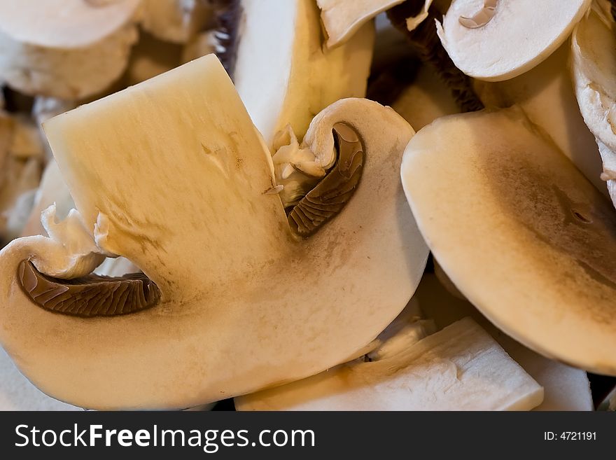 Cut up mushrooms wet and sliced on a cutting board