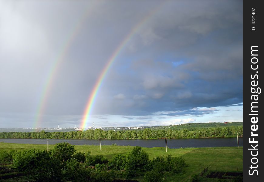 Landscape with rainbow over lake