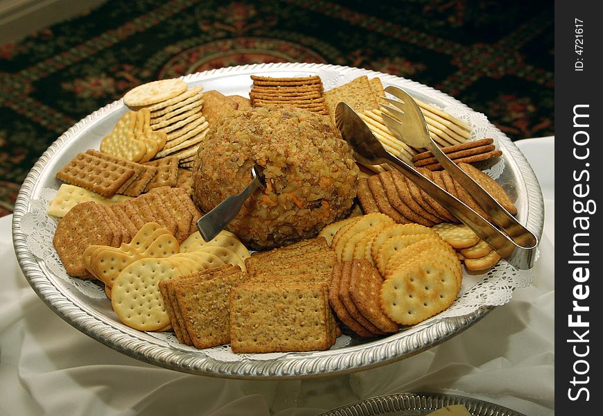 Cracker assortment arranged on serving tray with tongs