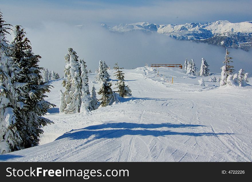 Ski slope on the top of mountain in the snow forest. Ski slope on the top of mountain in the snow forest