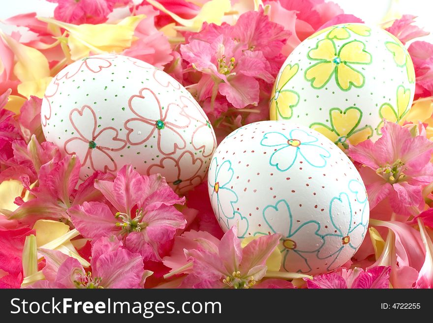 Three hand decorated Easter eggs rest inside a lovely petal and flower nest. Three hand decorated Easter eggs rest inside a lovely petal and flower nest.