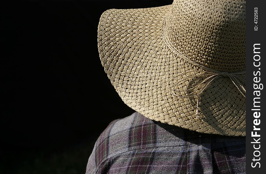 A mystery figure wearing a sun hat.