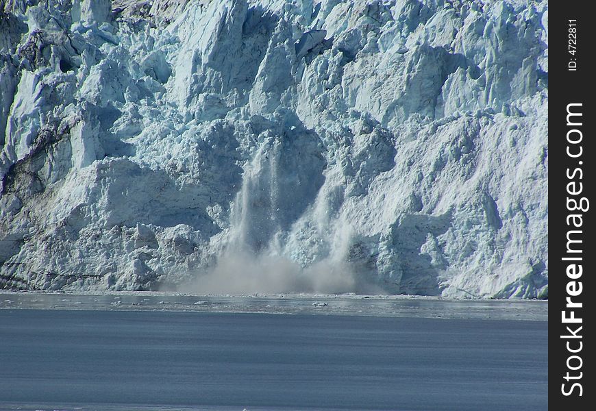 Ice calving off of Hubbard Glacier into the bay.  Taken from Disenchantment Bay  off the Alaska coast. Ice calving off of Hubbard Glacier into the bay.  Taken from Disenchantment Bay  off the Alaska coast.