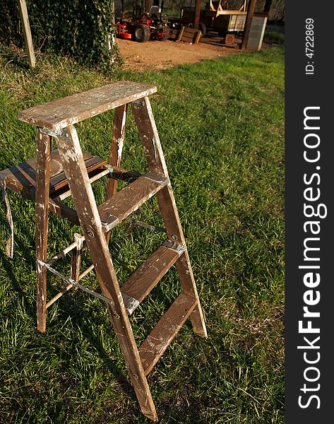 Wooden ladder on grass before barn