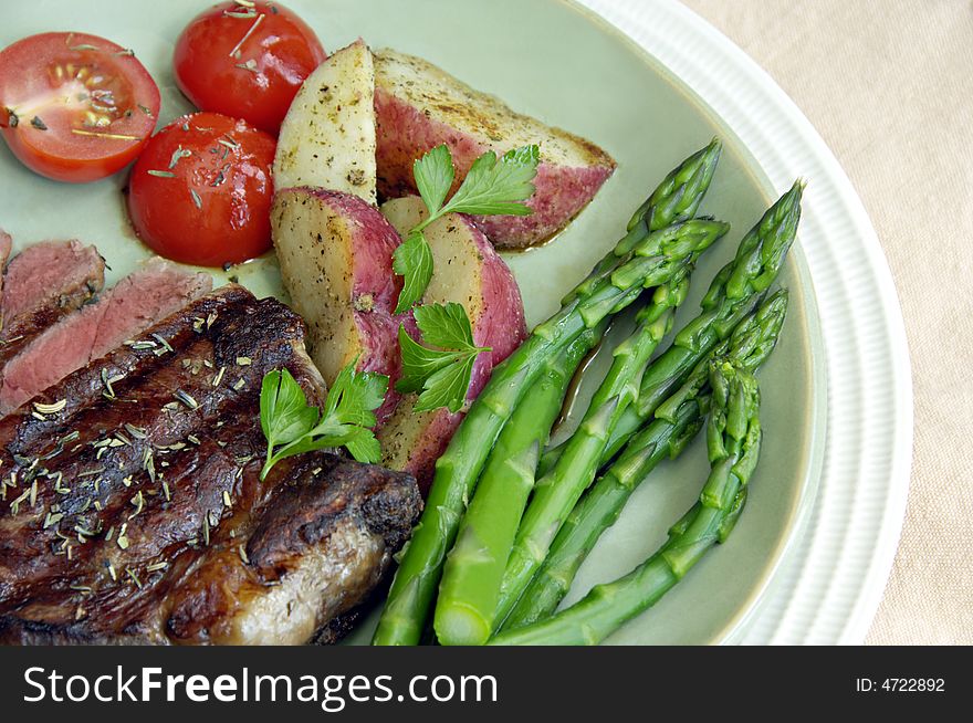 Steak with Potatoes, Tomatoes, and Asparagus