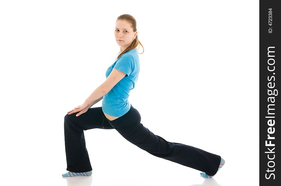 The beautiful young woman doing yoga exercise isolated on a white background. The beautiful young woman doing yoga exercise isolated on a white background