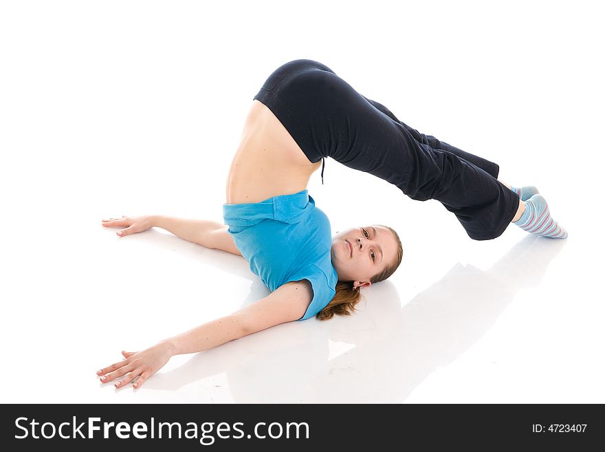 The beautiful young woman doing yoga exercise isolated on a white background. The beautiful young woman doing yoga exercise isolated on a white background