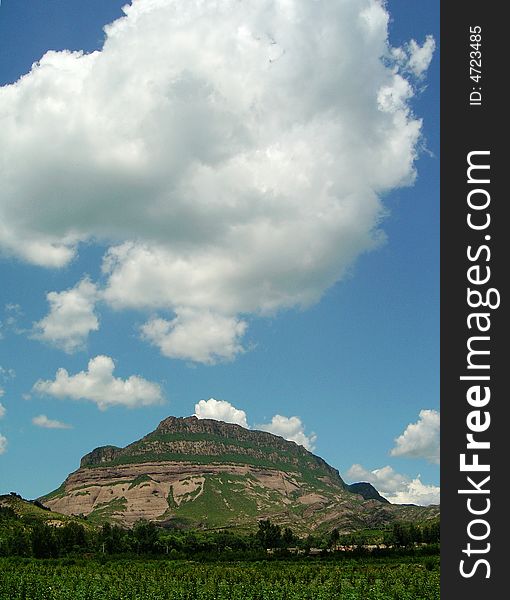 Magnificent mountain range under the blue sky and white cloud