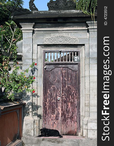 An old door leading to a private compound in Kerobokan, Bali. An old door leading to a private compound in Kerobokan, Bali
