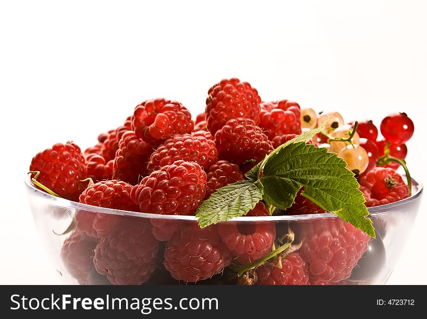 Raspberry and currant on the glassy bowl