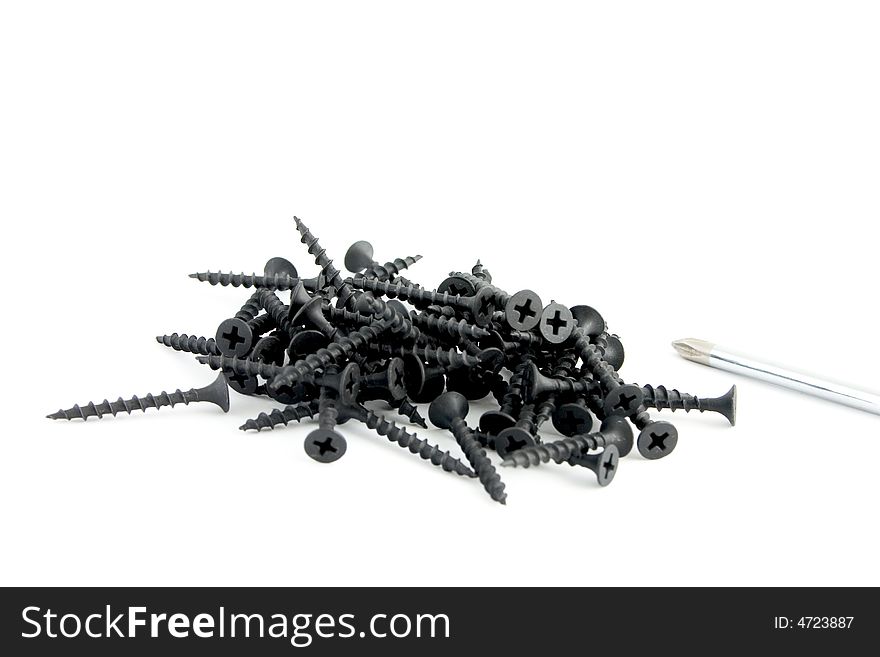 Handful of black wood screws with screwdriver isolated on white background. Handful of black wood screws with screwdriver isolated on white background.