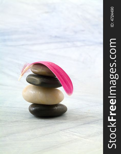 Balancing Stones And Pink Petal