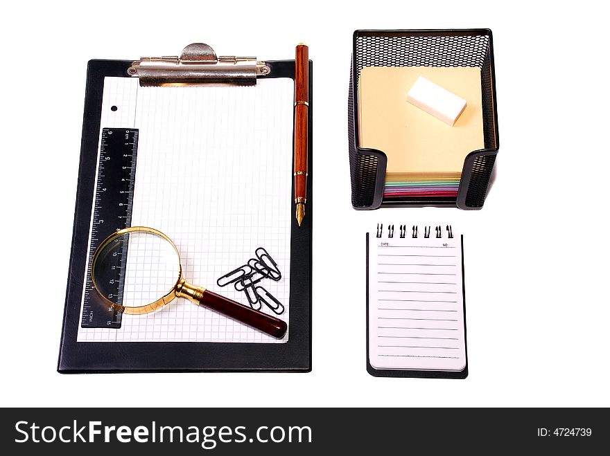 Office tools Magnifier, paper clips, a notebook, pencils