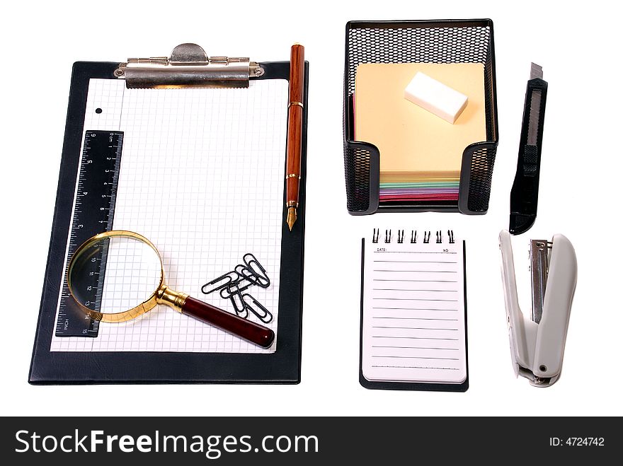 Office tools Magnifier, paper clips, a notebook, pencils