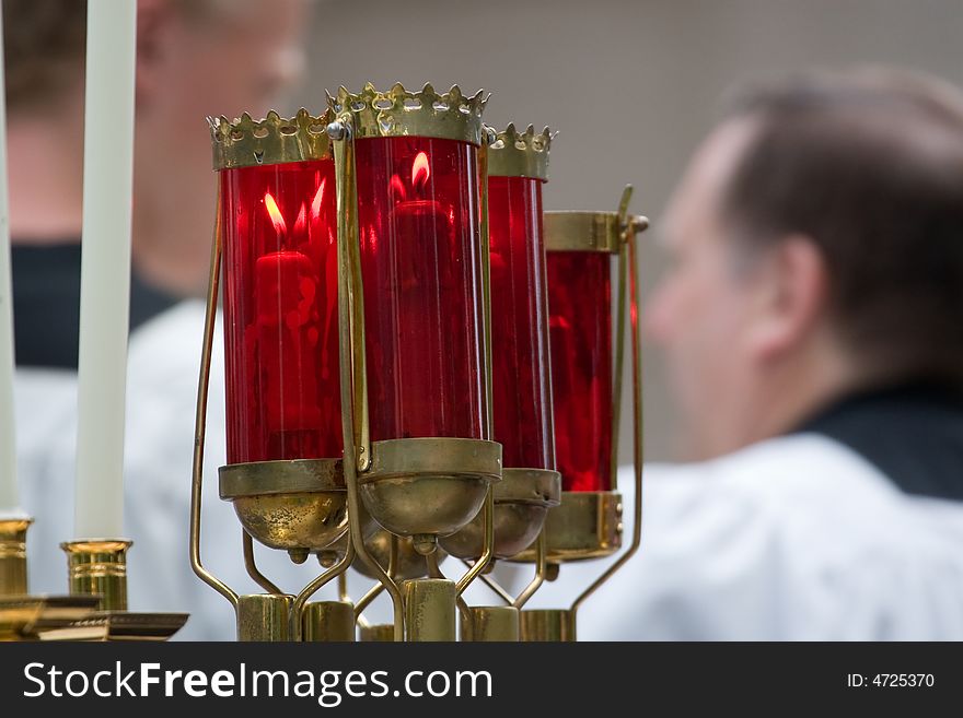 Red torches carrying candles in Catholic mass. Red torches carrying candles in Catholic mass