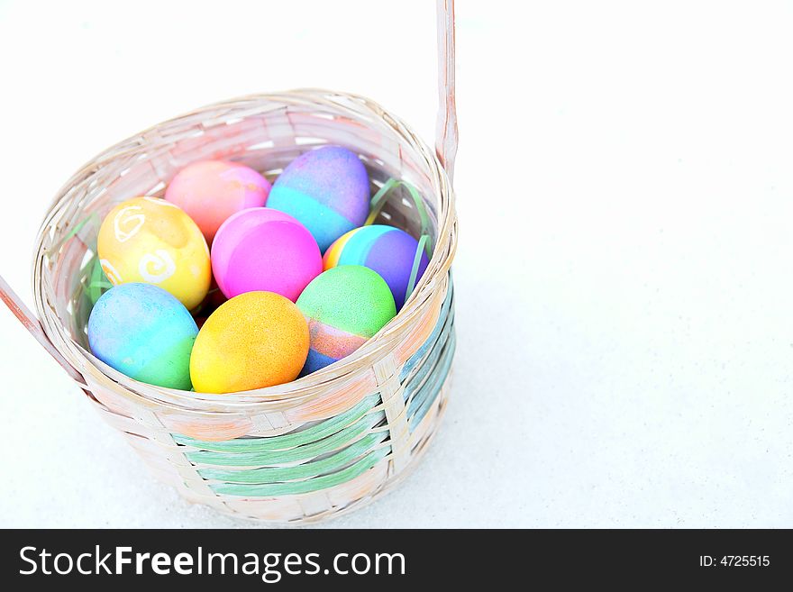 Easter basket filled with colourful eggs. Easter basket filled with colourful eggs