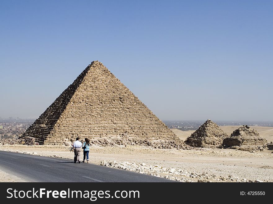 People go on road near pyramids