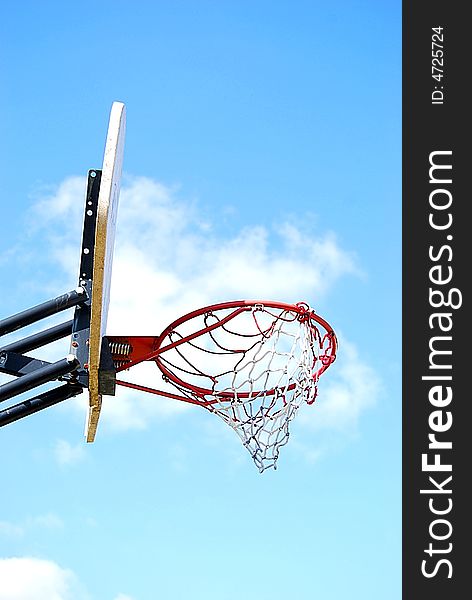 Basketball hoop in front of a blue sky