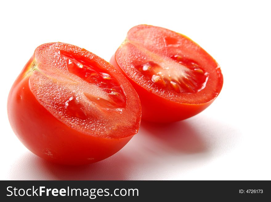 Red tomatos cutted isolated on white. Red tomatos cutted isolated on white
