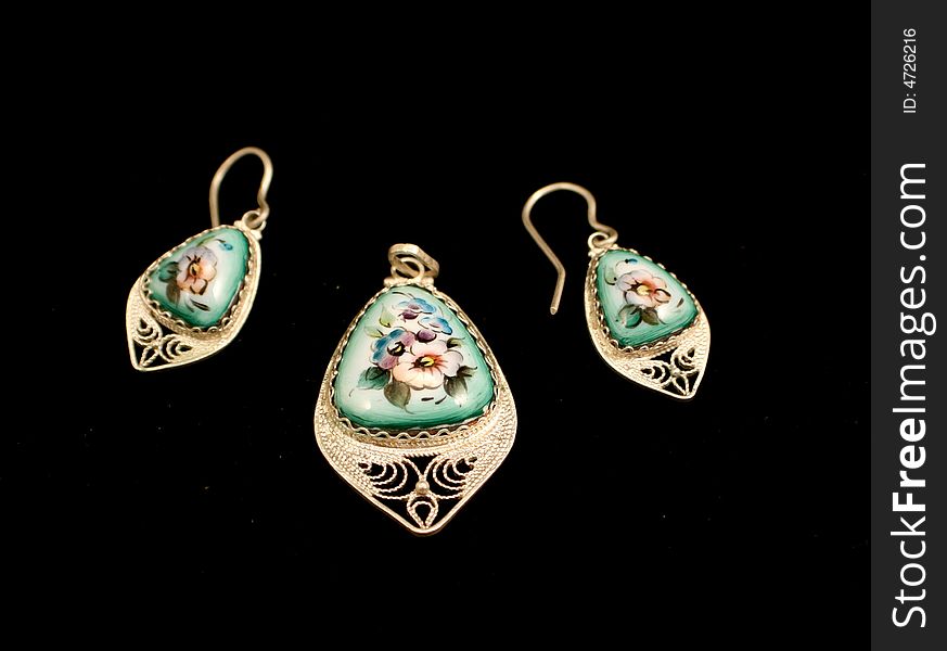 Pendant and earrings of painted and enameled porcelain on the black background. Pendant and earrings of painted and enameled porcelain on the black background