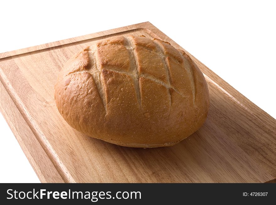 A loaf of sourdough bread on a wooden cutting board isolated against white, with clipping path. A loaf of sourdough bread on a wooden cutting board isolated against white, with clipping path.