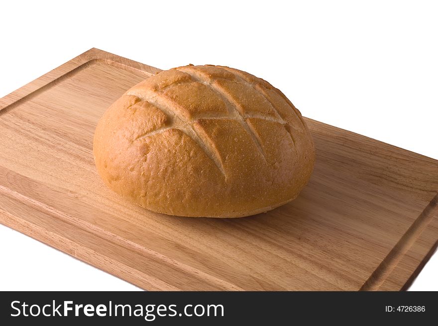 A loaf of sourdough bread on a wooden cutting board isolated against white, with clipping path. A loaf of sourdough bread on a wooden cutting board isolated against white, with clipping path.