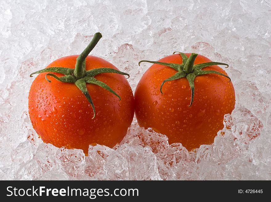 Red ripe tomatoes on bed of cracked ice