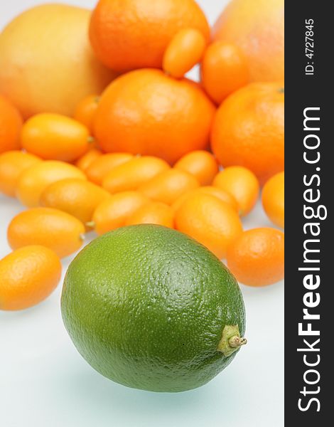 Citrus on a white glass table,focus on a lime