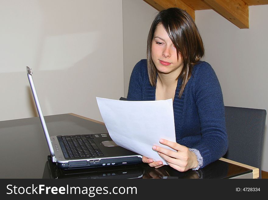 A young woman working at home with notebook