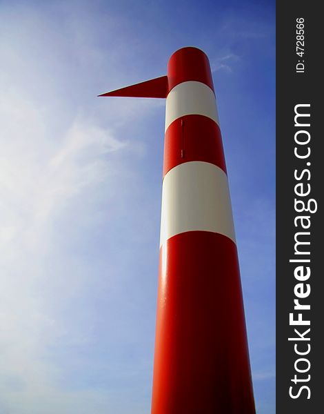 Red and white beach tower with sky background