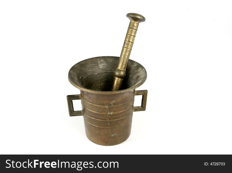 Brass mortar and pestle on white